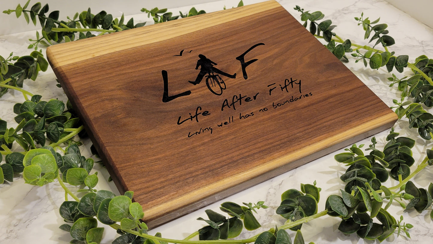 Small kitchen-friendly walnut board with engraving branded for an organization.